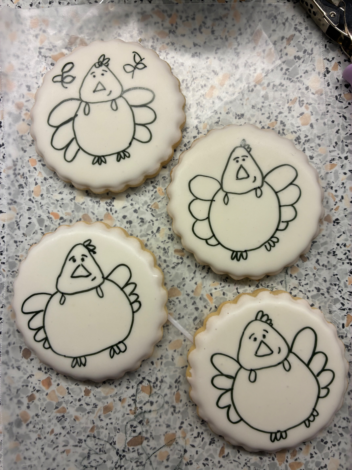 Four iced turkey cookies ready to paint